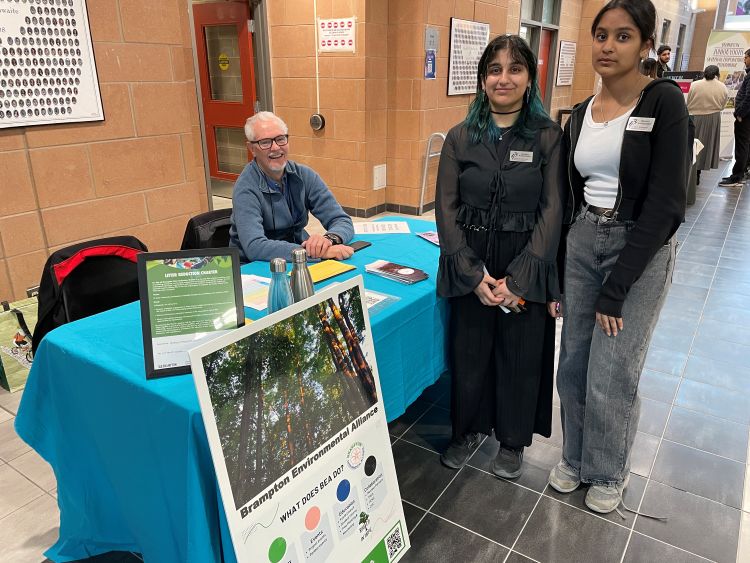 David Laing speaks with 2 of the student ambassadors from Harold M. Brathwaite Parent Teacher night.